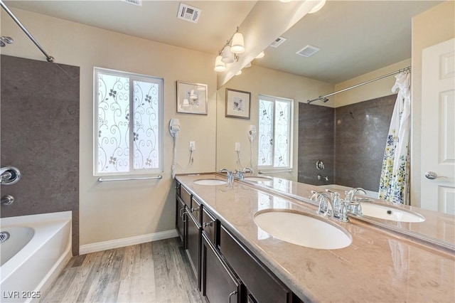8565 Silver Coast St, Las Vegas, NV 89139 - full bathroom with double vanity, wood finished floors, and shower / bath combo