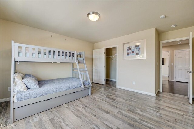 8565 Silver Coast St, Las Vegas, NV 89139 - bedroom with wood finished floors, a closet, and a walk in closet