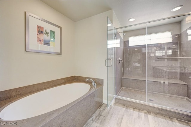 8565 Silver Coast St, Las Vegas, NV 89139 - bathroom featuring a bath, a stall shower, and recessed lighting