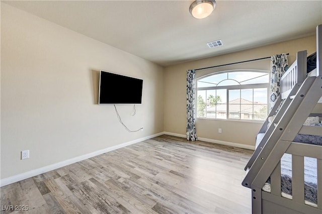 8565 Silver Coast St, Las Vegas, NV 89139 - unfurnished bedroom featuring wood finished floors and baseboards
