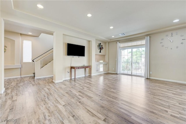 8565 Silver Coast St, Las Vegas, NV 89139 - unfurnished living room featuring wood finished floors, recessed lighting, and stairs