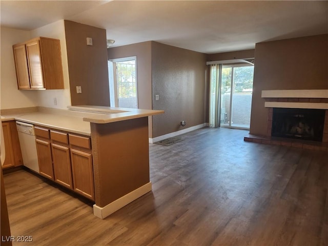 2986 Juniper Hills Blvd Unit 202, Las Vegas, NV 89142 - kitchen featuring dishwasher, a peninsula, open floor plan, and light wood-style flooring