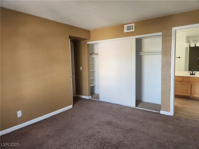 2986 Juniper Hills Blvd Unit 202, Las Vegas, NV 89142 - unfurnished bedroom with carpet, a closet, and ensuite bath