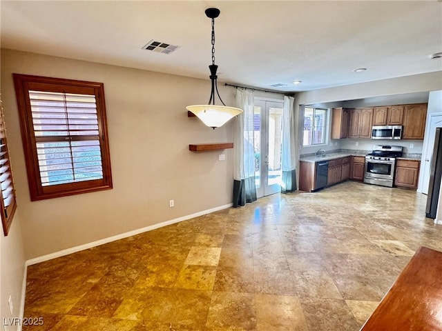 5361 Candlespice Way, Las Vegas, NV 89135 - kitchen with stainless steel appliances, light countertops, decorative light fixtures, french doors, and brown cabinetry
