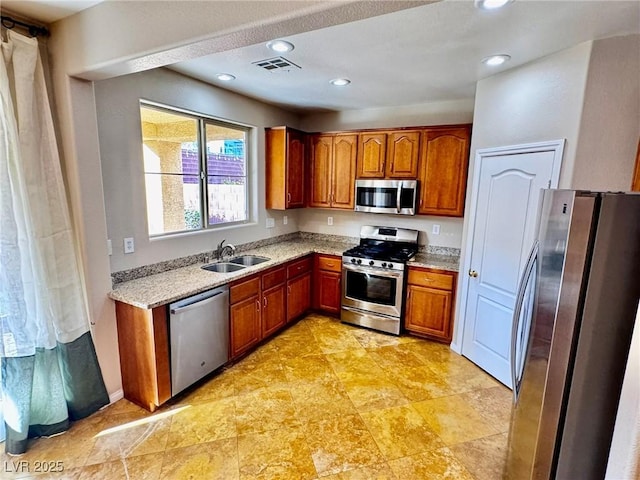 5361 Candlespice Way, Las Vegas, NV 89135 - kitchen with appliances with stainless steel finishes, light stone countertops, brown cabinets, and recessed lighting