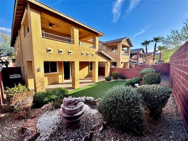 5361 Candlespice Way, Las Vegas, NV 89135 - rear view of house featuring stucco siding, a fenced backyard, a balcony, and a patio area