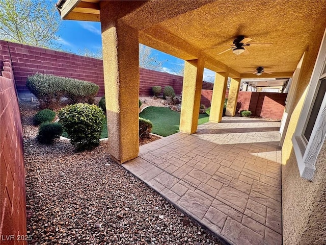 5361 Candlespice Way, Las Vegas, NV 89135 - fenced backyard featuring ceiling fan and a patio