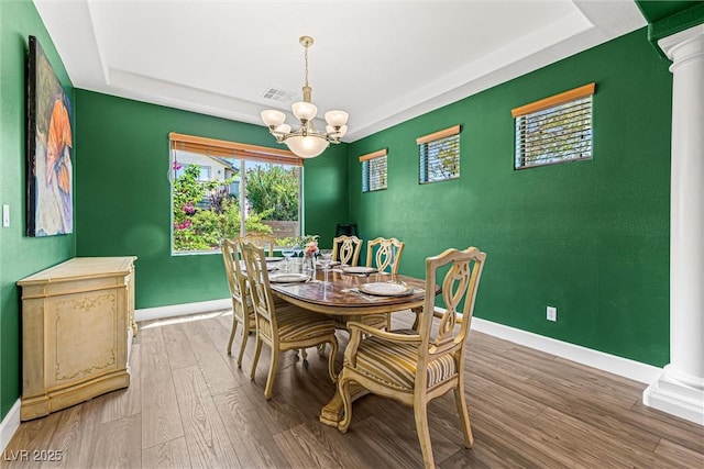 3405 Brook Song Ave, North Las Vegas, NV 89081 - dining space with decorative columns, a chandelier, and a raised ceiling