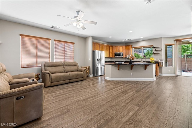 3405 Brook Song Ave, North Las Vegas, NV 89081 - living room with a ceiling fan, wood finished floors, and recessed lighting