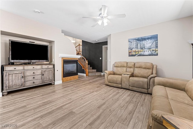 3405 Brook Song Ave, North Las Vegas, NV 89081 - living room featuring light wood finished floors, a ceiling fan, and stairway