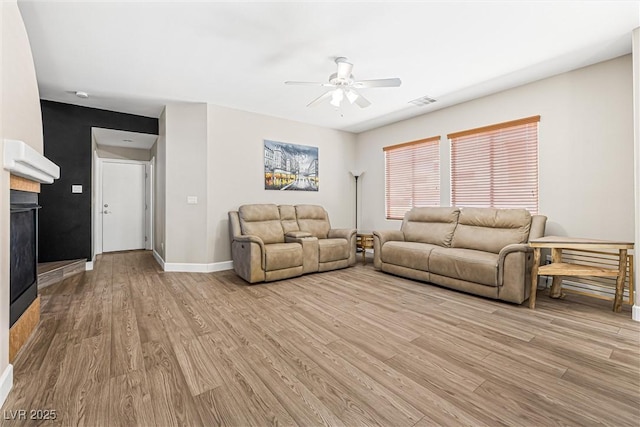 3405 Brook Song Ave, North Las Vegas, NV 89081 - living area with ceiling fan, light wood-type flooring, and a fireplace