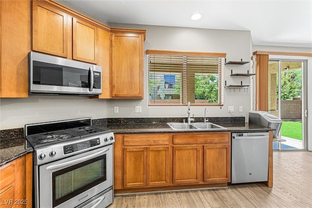 3405 Brook Song Ave, North Las Vegas, NV 89081 - kitchen featuring stainless steel appliances, brown cabinets, light wood-type flooring, and recessed lighting