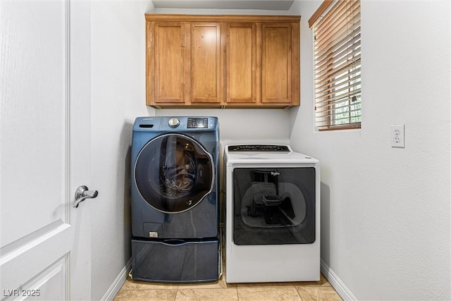 3405 Brook Song Ave, North Las Vegas, NV 89081 - laundry room with independent washer and dryer, cabinet space, and light tile patterned floors