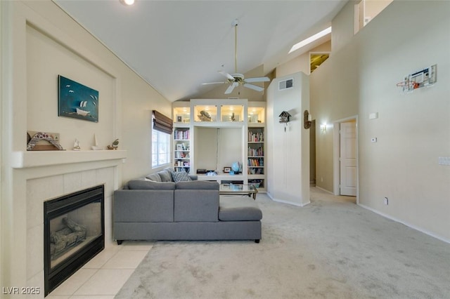 2925 Wigwam Pkwy Unit 1124, Henderson, NV 89074 - living room with a ceiling fan, a tiled fireplace, carpet flooring, and high vaulted ceiling