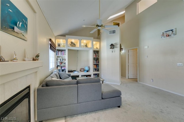 2925 Wigwam Pkwy Unit 1124, Henderson, NV 89074 - carpeted living room with ceiling fan, a tile fireplace, and high vaulted ceiling