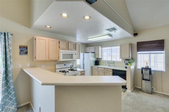 2925 Wigwam Pkwy Unit 1124, Henderson, NV 89074 - kitchen with white appliances, a peninsula, light brown cabinetry, light countertops, and light carpet