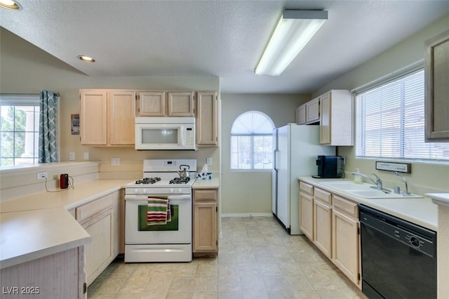2925 Wigwam Pkwy Unit 1124, Henderson, NV 89074 - kitchen featuring white appliances, light brown cabinetry, light countertops, recessed lighting, and a textured ceiling