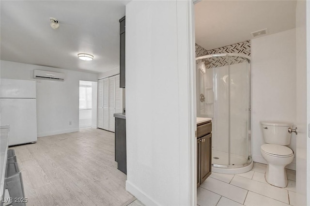 1708 Cedar Ave, Las Vegas, NV 89101 - bathroom with an AC wall unit, a shower stall, vanity, and wood finished floors
