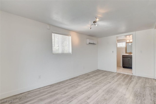 1708 Cedar Ave, Las Vegas, NV 89101 - empty room featuring an AC wall unit and light wood finished floors
