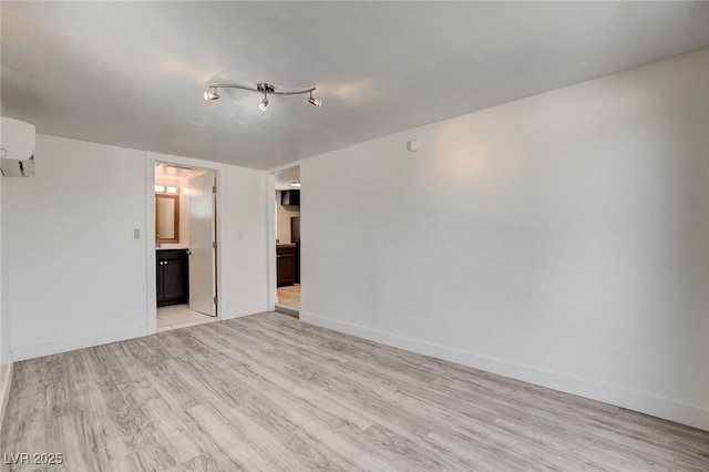 1708 Cedar Ave, Las Vegas, NV 89101 - unfurnished room with a wall unit AC and light wood-style flooring
