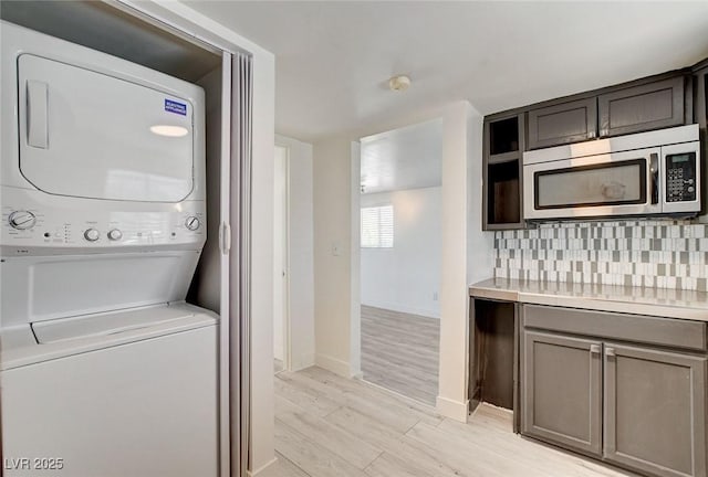 1708 Cedar Ave, Las Vegas, NV 89101 - washroom with stacked washer and clothes dryer and light wood-type flooring