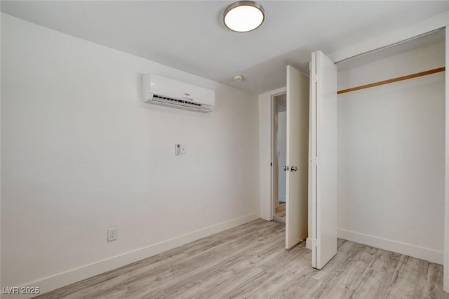 1708 Cedar Ave, Las Vegas, NV 89101 - unfurnished bedroom with a wall unit AC, light wood finished floors, and a closet