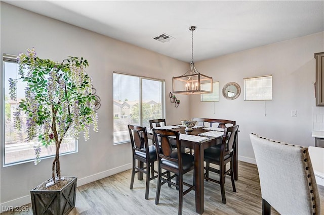 5220 Melbourne Ridge Ct, Las Vegas, NV 89141 - dining space featuring light wood-type flooring and a chandelier