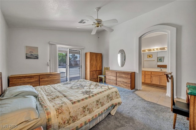 5139 Zapata Ln, North Las Vegas, NV 89031 - bedroom with access to outside, lofted ceiling, light colored carpet, light tile patterned floors, and connected bathroom