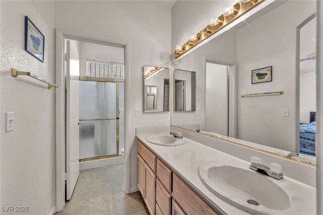 5139 Zapata Ln, North Las Vegas, NV 89031 - bathroom with marble finish floors, double vanity, and a shower stall