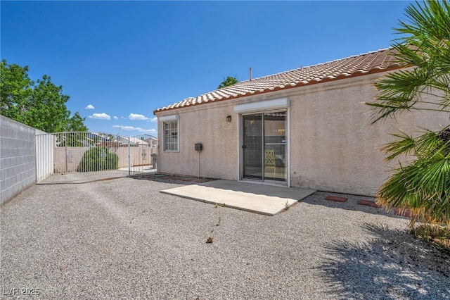5139 Zapata Ln, North Las Vegas, NV 89031 - back of property with a tile roof, stucco siding, a gate, and a patio
