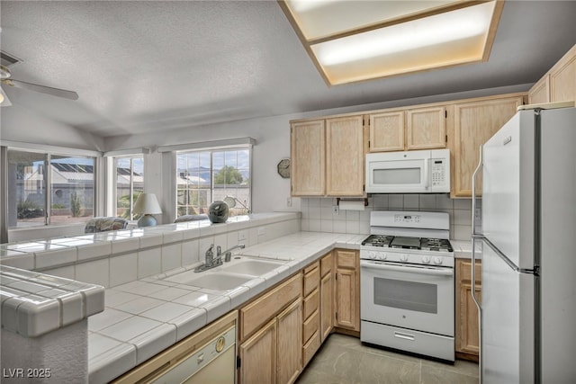 5139 Zapata Ln, North Las Vegas, NV 89031 - kitchen with white appliances, light brown cabinetry, tile countertops, a ceiling fan, and a peninsula