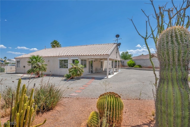 5139 Zapata Ln, North Las Vegas, NV 89031 - view of front of house featuring a patio area, a fenced backyard, stucco siding, and a tiled roof