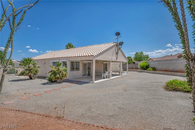 5139 Zapata Ln, North Las Vegas, NV 89031 - back of house featuring a tile roof, a patio area, stucco siding, and a fenced backyard