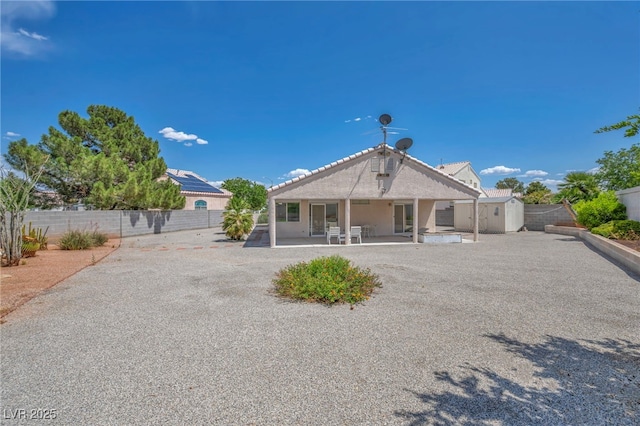 5139 Zapata Ln, North Las Vegas, NV 89031 - rear view of house with a storage shed, a patio, a fenced backyard, and stucco siding