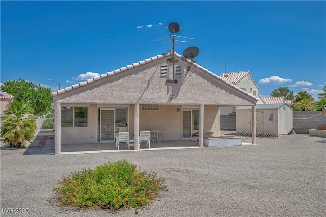 5139 Zapata Ln, North Las Vegas, NV 89031 - rear view of house with a storage unit, a patio, stucco siding, and a tiled roof