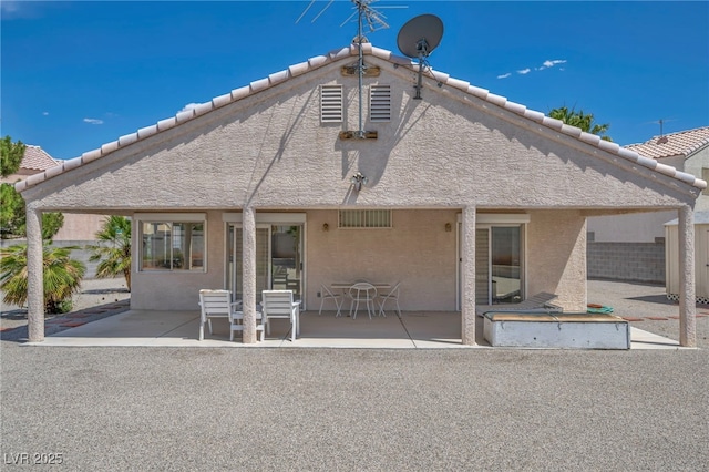 5139 Zapata Ln, North Las Vegas, NV 89031 - rear view of house featuring a patio, a tile roof, and stucco siding