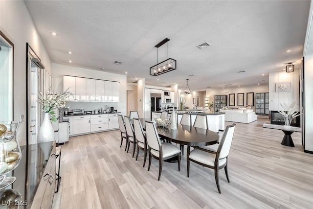 5438 Sierra Brook Ct, Las Vegas, NV 89149 - dining room with light wood-style floors, a textured ceiling, plenty of natural light, and recessed lighting