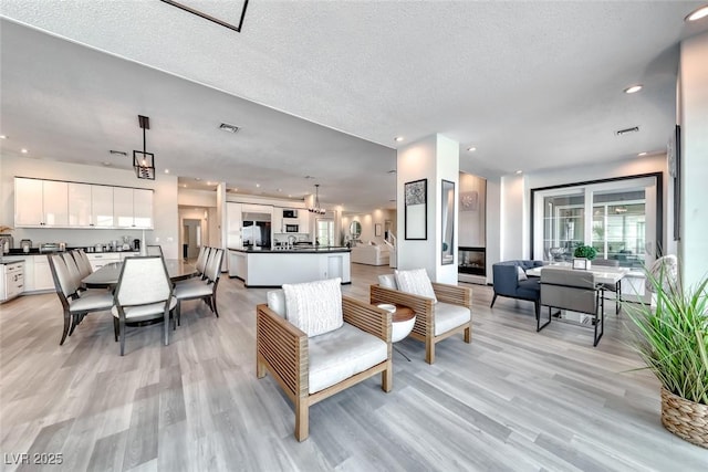 5438 Sierra Brook Ct, Las Vegas, NV 89149 - living area featuring light wood-style flooring and recessed lighting