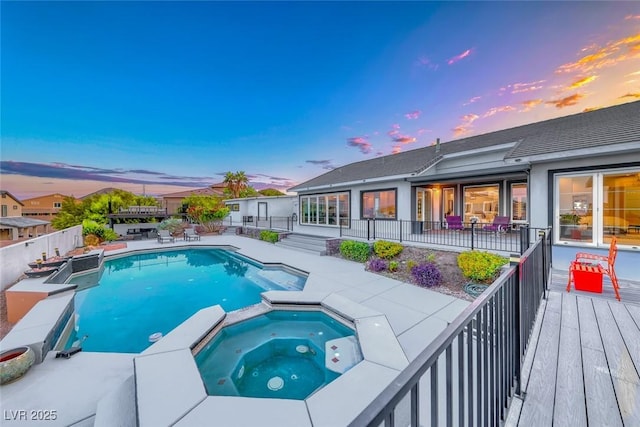 5438 Sierra Brook Ct, Las Vegas, NV 89149 - pool at dusk featuring a pool with connected hot tub, a fenced backyard, and a patio