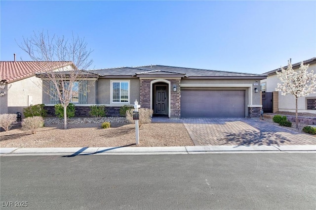 10095 Ferton Lake Ave, Las Vegas, NV 89178 - ranch-style house featuring stone siding, stucco siding, an attached garage, and decorative driveway