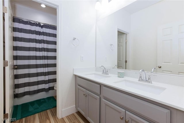 10095 Ferton Lake Ave, Las Vegas, NV 89178 - bathroom featuring double vanity, wood finished floors, and a shower with curtain