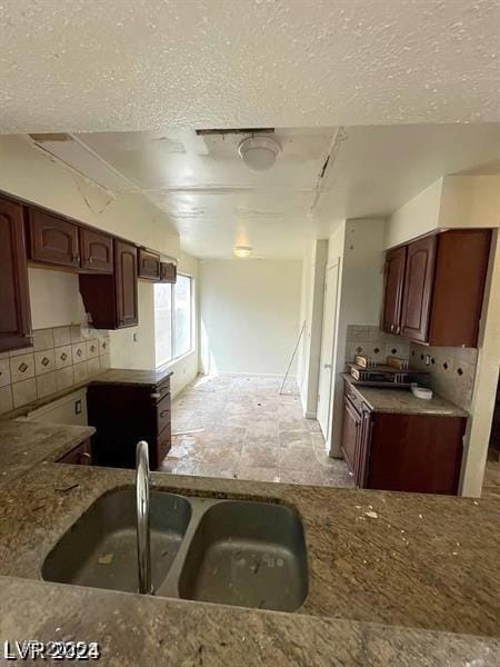 1745 Starridge Way, Las Vegas, NV 89142 - kitchen featuring tasteful backsplash, stone counters, and a textured ceiling