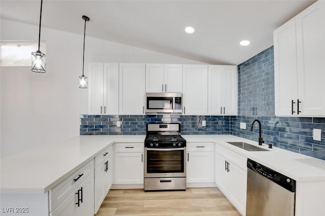 116 Lotus Blossom Ct, Las Vegas, NV 89145 - kitchen with stainless steel appliances, a peninsula, lofted ceiling, decorative backsplash, and recessed lighting