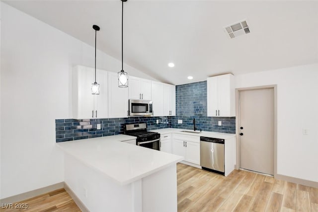 116 Lotus Blossom Ct, Las Vegas, NV 89145 - kitchen with appliances with stainless steel finishes, backsplash, a peninsula, light countertops, and white cabinets