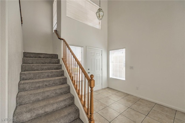7977 Blue Brook Dr, Las Vegas, NV 89147 - staircase with a high ceiling and tile patterned floors