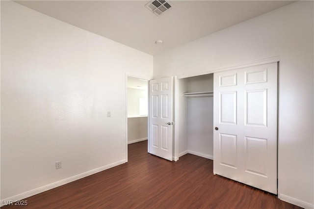 7977 Blue Brook Dr, Las Vegas, NV 89147 - unfurnished bedroom with dark wood-style flooring and a closet