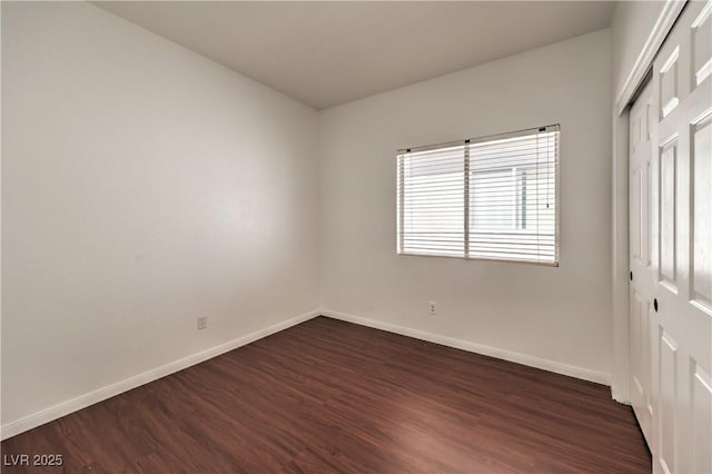 7977 Blue Brook Dr, Las Vegas, NV 89147 - unfurnished bedroom with dark wood-type flooring and a closet