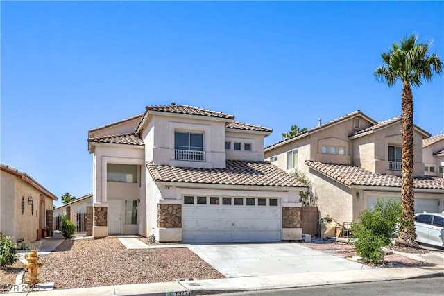 7977 Blue Brook Dr, Las Vegas, NV 89147 - mediterranean / spanish home featuring a tiled roof, stone siding, driveway, stucco siding, and an attached garage