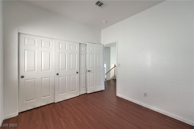7977 Blue Brook Dr, Las Vegas, NV 89147 - unfurnished bedroom featuring dark wood-style floors and a closet