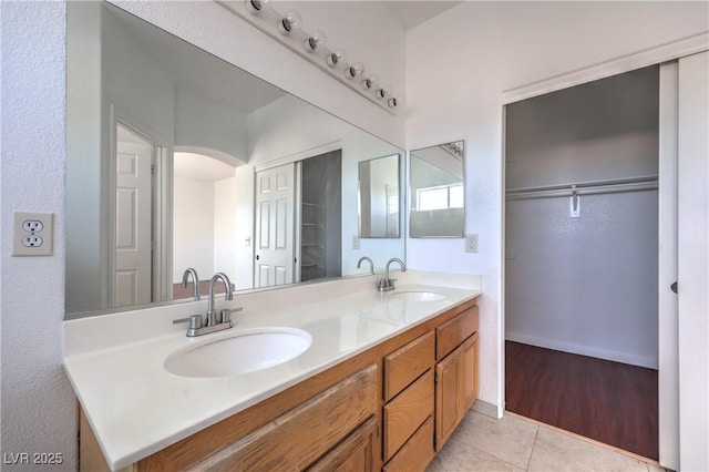 7977 Blue Brook Dr, Las Vegas, NV 89147 - full bathroom featuring double vanity, tile patterned flooring, and a spacious closet